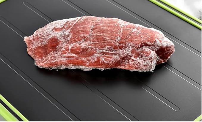 Frozen meat on fast defrosting chopping board for quick meal prep.